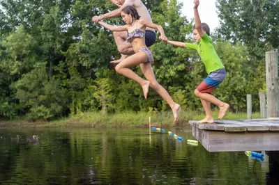 The Futrell family jumping off a dock
