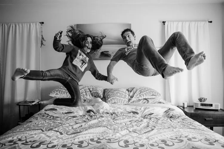 Rob and Elizabeth jumping on the bed