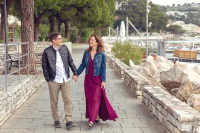 Rob and Jill Futrell walking hand in hand by the waterfront