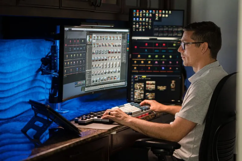 Rob Futrell culling and editing photos at his multi-monitor workstation