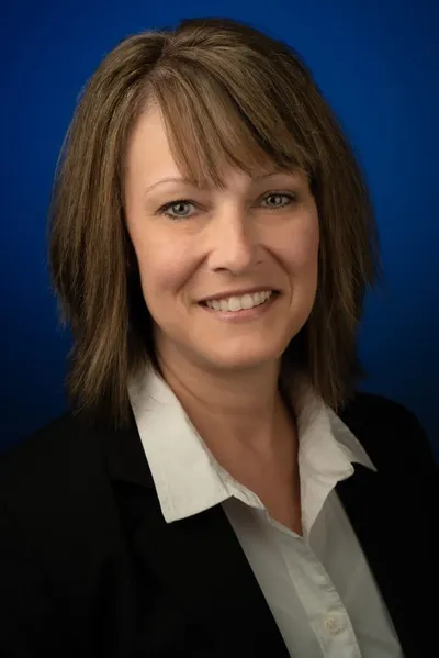 Professional business headshot, woman with blue background, St. Augustine