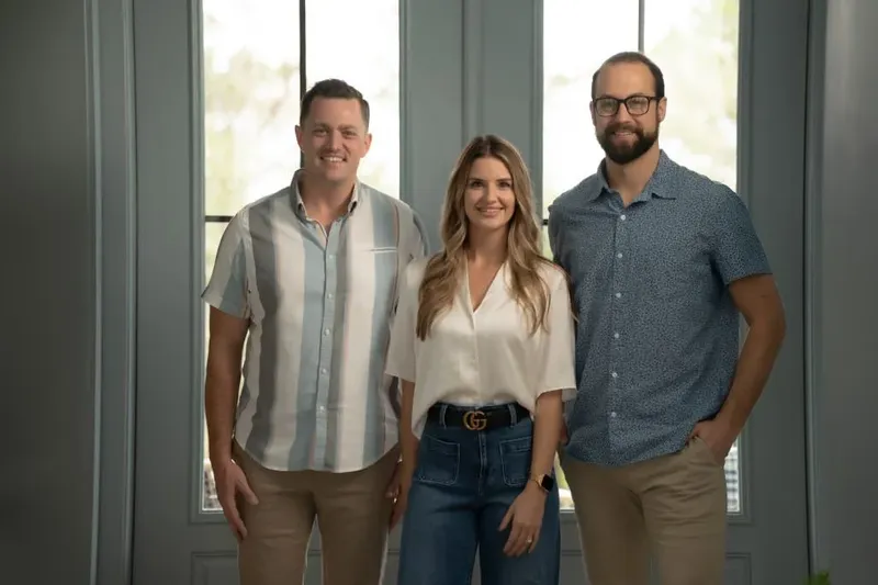 St Augustine corporate team photo by tall windows