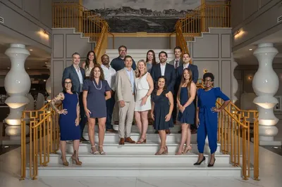 Corporate team photo on grand staircase at historic venue