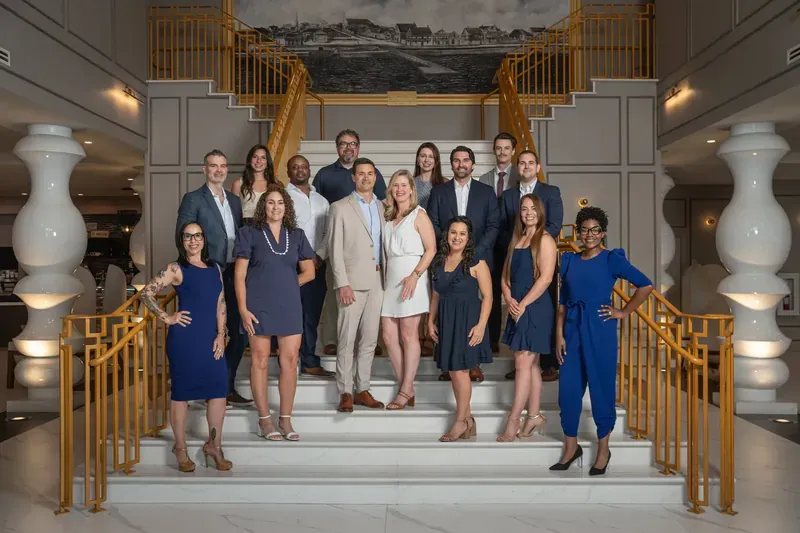 Corporate team photo on grand staircase at historic venue