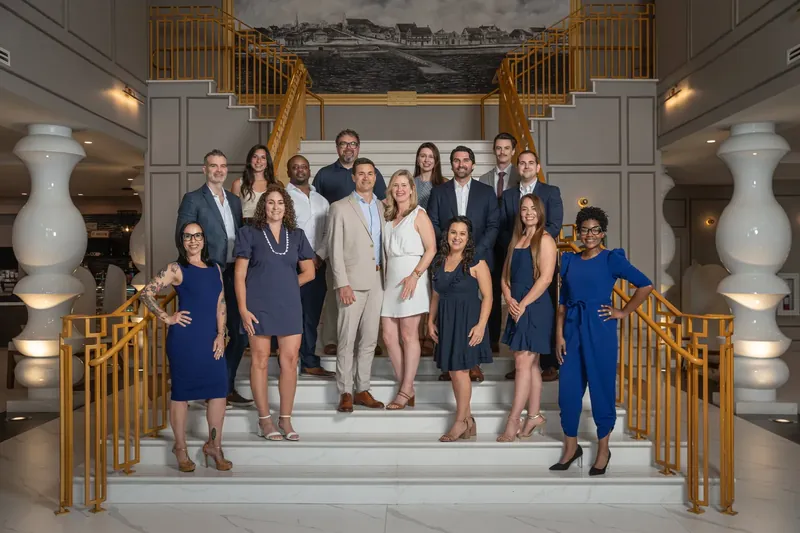 Corporate team photo on grand staircase at historic venue