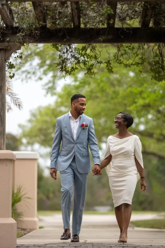 Couple walking under pergola after St Johns County courthouse wedding