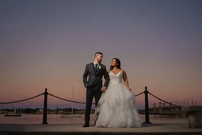 Couple portrait on bayfront at sunset with purple sky