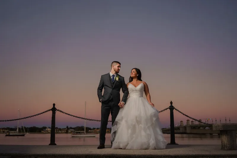 Couple portrait on bayfront at sunset with purple sky in St Augustine