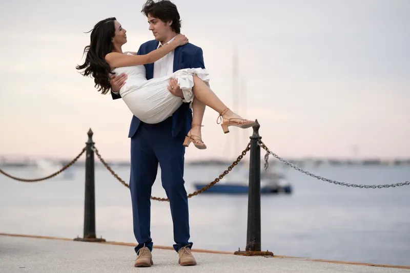 Groom carries bride at St Augustine bayfront marina