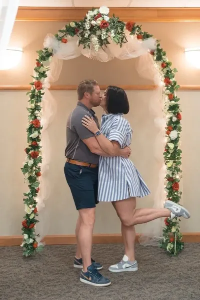First kiss under floral arch at St Johns County Courthouse elopement
