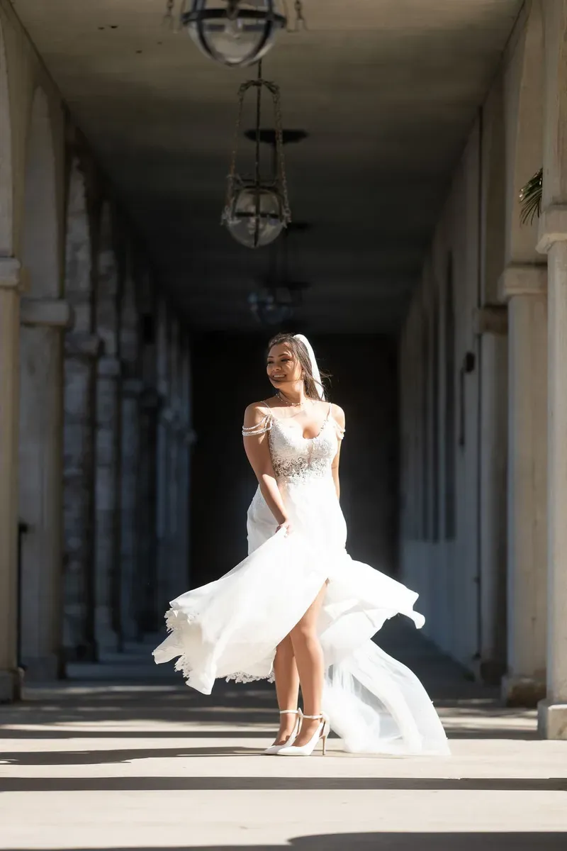 Bride twirling in Flagler College colonnade with dress flowing