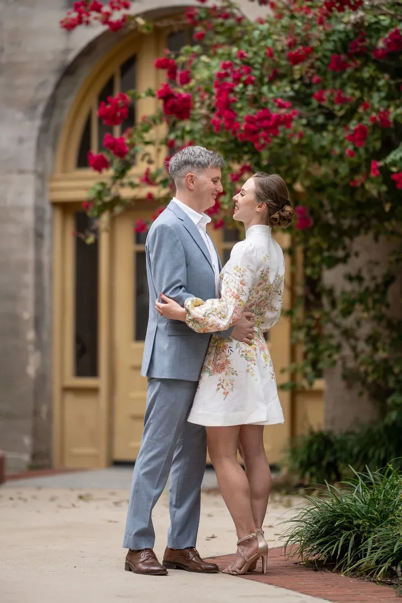 Couple embraces near vibrant bougainvillea during St Augustine elopement