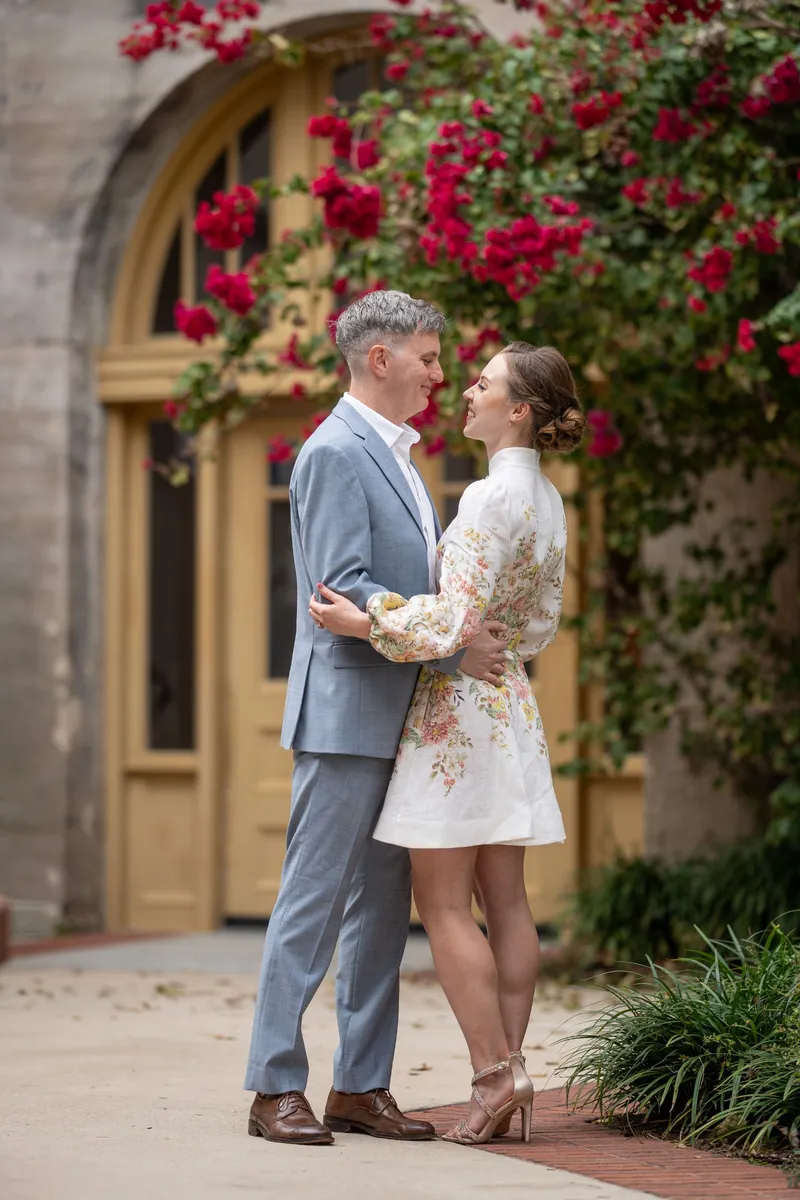 Couple embraces near vibrant bougainvillea during St Augustine elopement