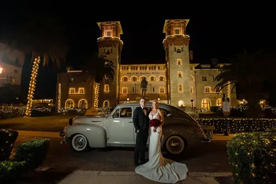 Couple with vintage car at Lightner Museum during Nights of Lights