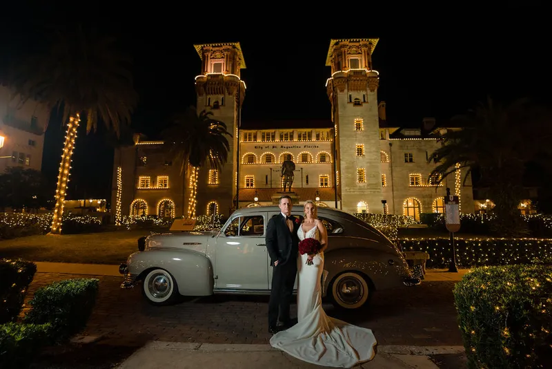 Couple with vintage car at Lightner Museum during Nights of Lights
