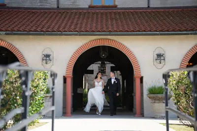 Couple walking under Spanish arches at Casa Monica St Augustine