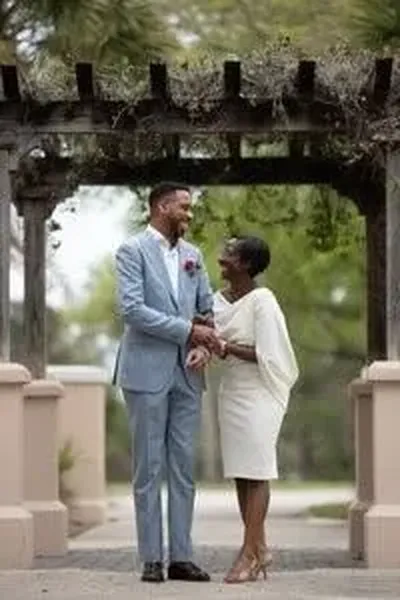 Joyful couple under arbor at St Augustine elopement
