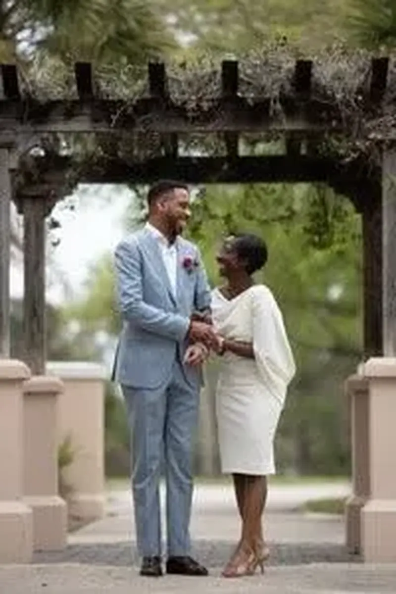Joyful couple under arbor at St Augustine elopement