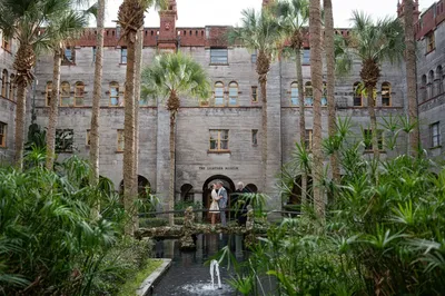 Couple embraces at Lightner Museum surrounded by lights at night