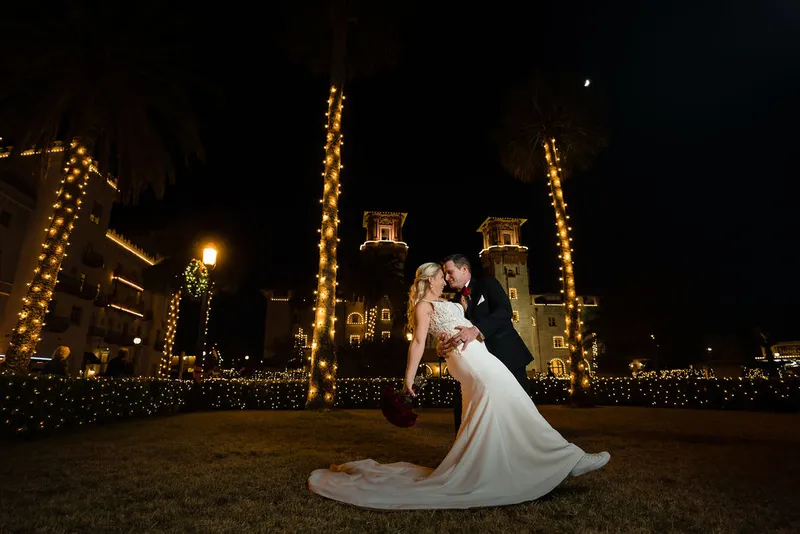 Groom dips bride during Nights of Lights at Lightner Museum
