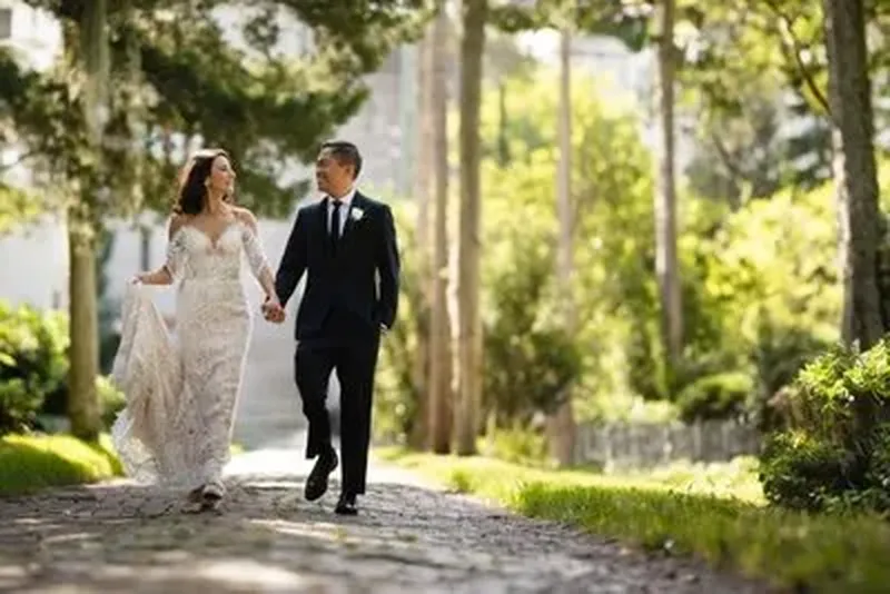 Couple walking on sunlit palm-lined path in St Augustine