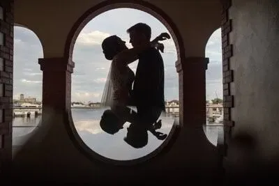 Couple silhouette in arch window at White Room with waterfront view