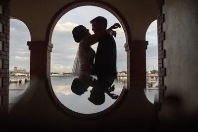 Couple silhouette in arch window at White Room with waterfront view