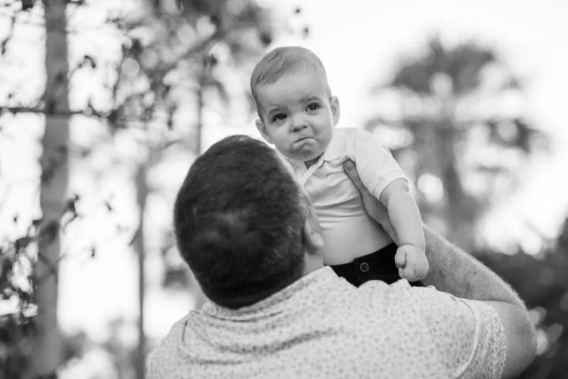Dad lifting son in playful portrait