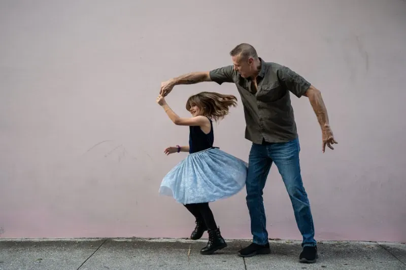 Father spinning daughter during family session
