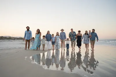 Family walking on the beach at golden hour in St. Augustine