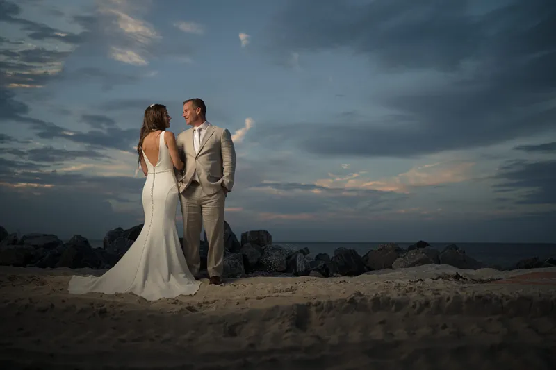 Couple walking on beach at sunset