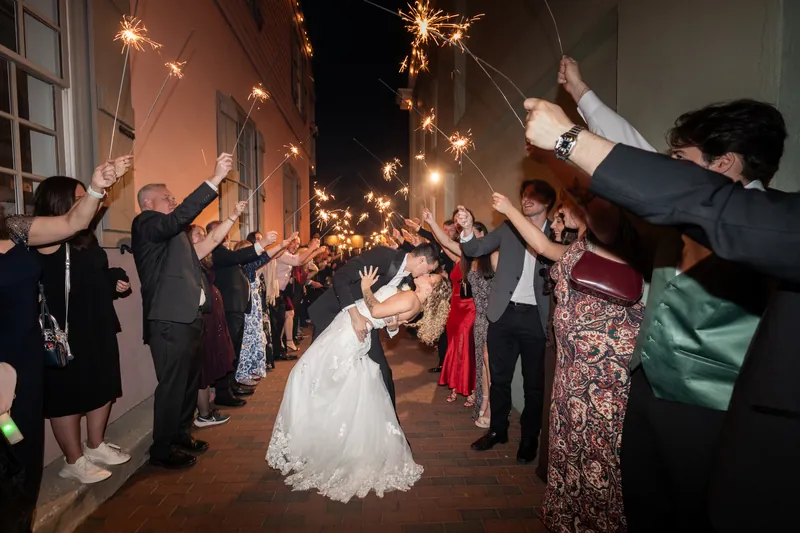 Sparkler exit with groom dipping bride for a kiss in downtown St. Augustine alley