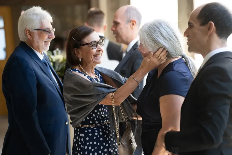 Family members embrace and celebrate together at the reception, expressions full of joy and connection.
