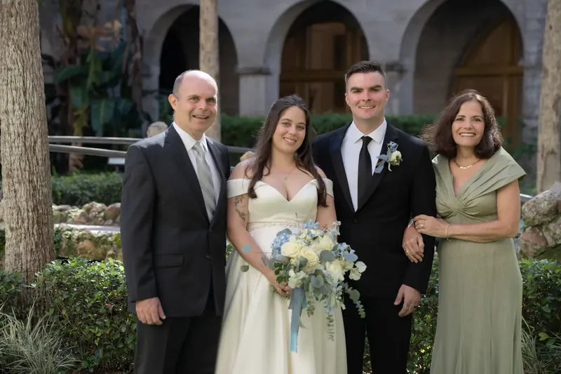 Ana and Bailey pose with two family members beneath the Lightner Museum's arched colonnades in St. Augustine.
