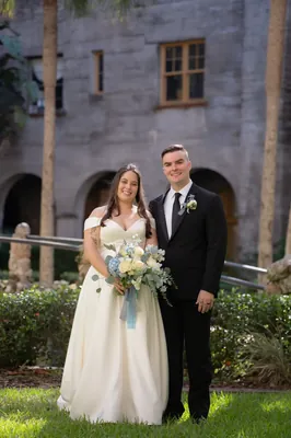 White wedding dress hanging in archway at Lightner Museum, St. Augustine wedding photographer