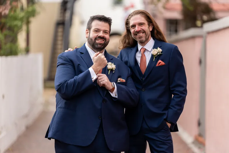 Chase and his best man bumping fists and posing together in a downtown St. Augustine alley