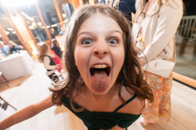 Iris making a silly face right at the camera during the reception