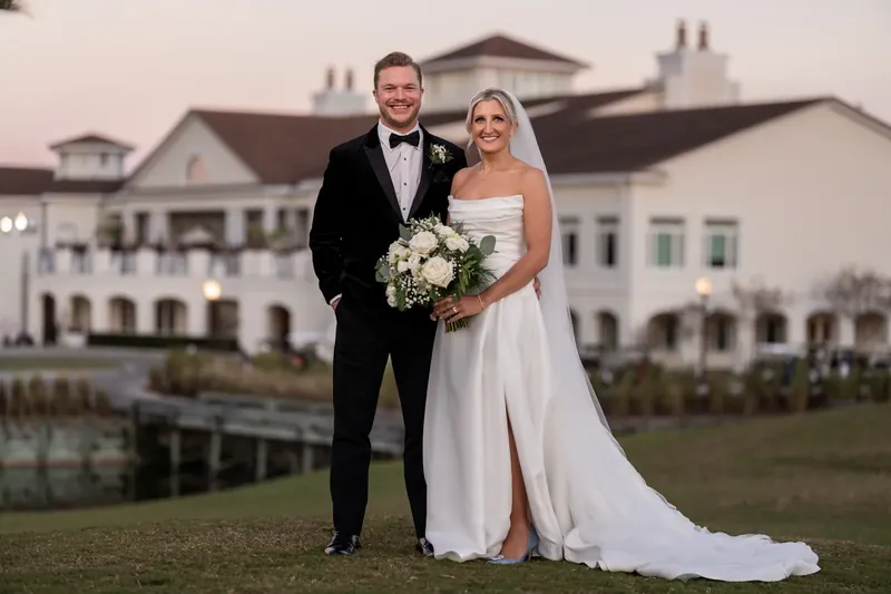 Ashley and Craig stand together before the main building at Sawgrass Marriott Golf Resort & Spa, Jacksonville.