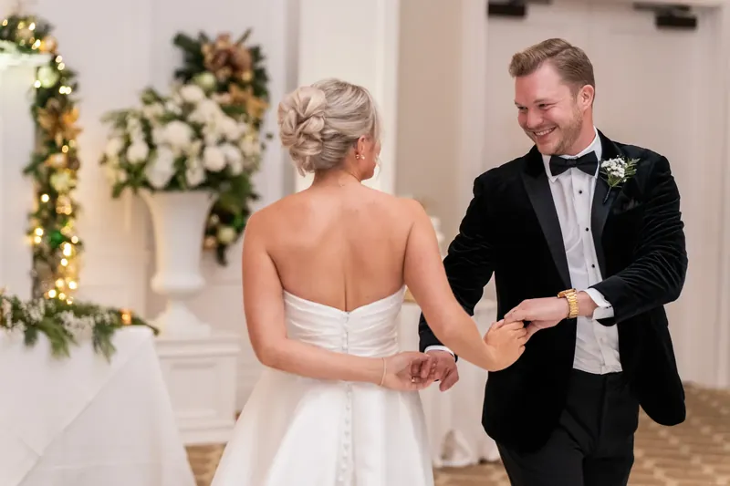 Craig grins as he presents Ashley's hand to family members during their first dance at Sawgrass Marriott Golf Resort & Spa.
