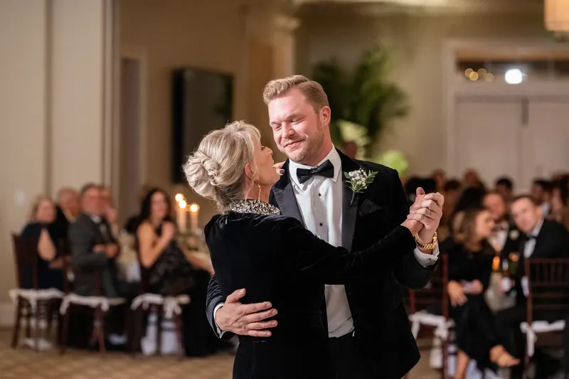 Craig and an older woman dance together at the Sawgrass Marriott, surrounded by seated guests in formal attire.