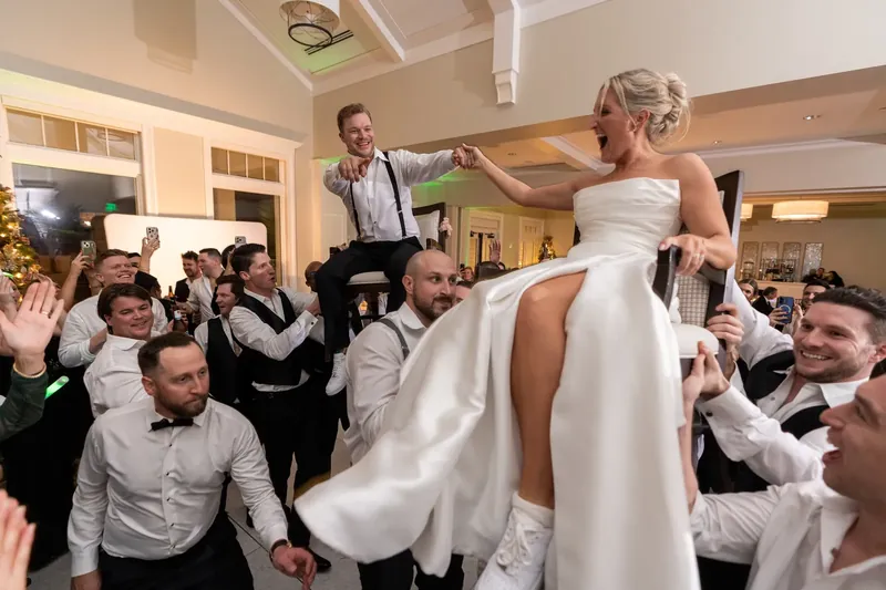 Ashley twirls her flowing white gown while guests watch and celebrate around her on the dance floor.