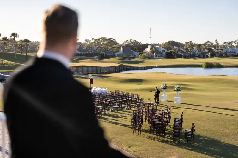 Craig looks out over the golf course and water features at Sawgrass Marriott in his formal attire.