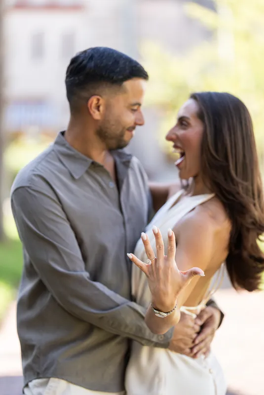 Beltran and Gabriela face each other with interlocked hands and genuine smiles in the Palm Row street setting.