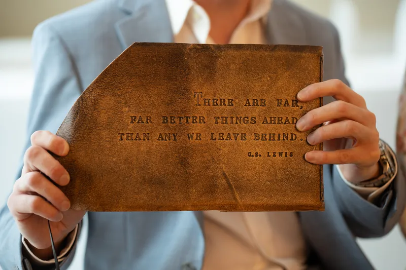 Couple seated together reading vows in empty chapel