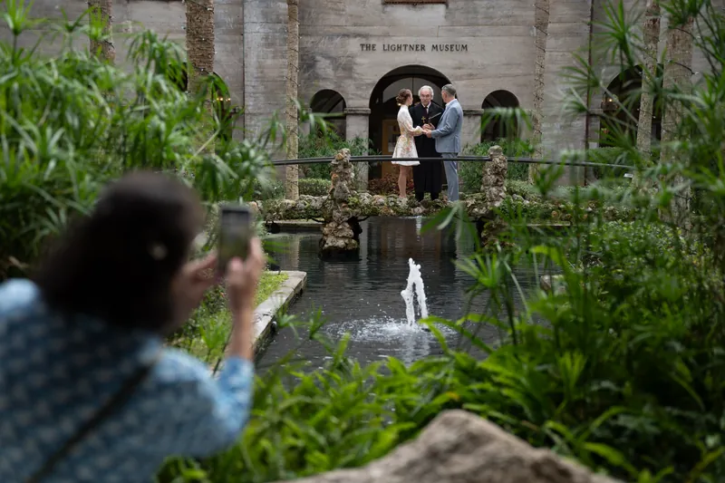Couple exchanging vows on courtyard bridge