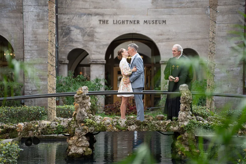 First kiss on bridge over reflecting pool