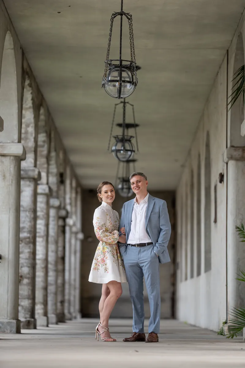 Couple portrait under hanging lanterns in corridor