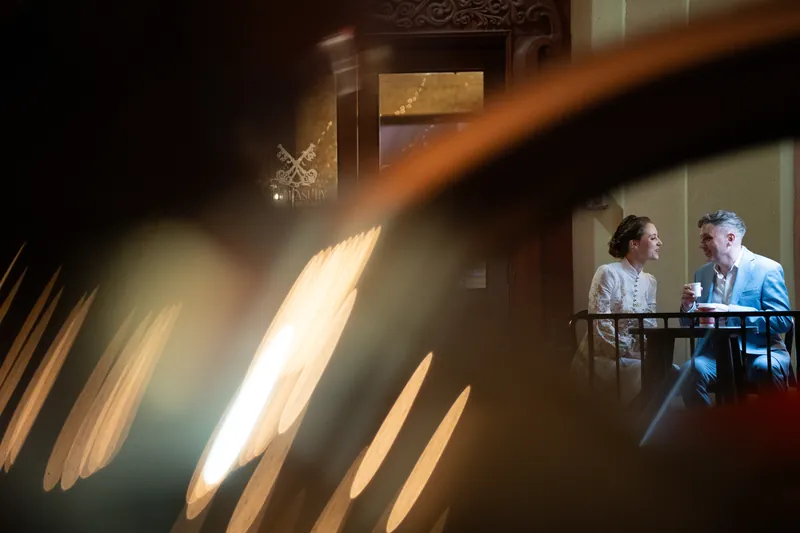 Couple sharing coffee at The Treasury at dusk