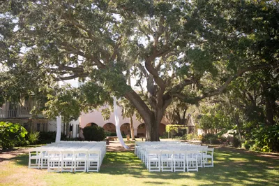 Groom with mother under coquina archway at the Oldest House St Augustine