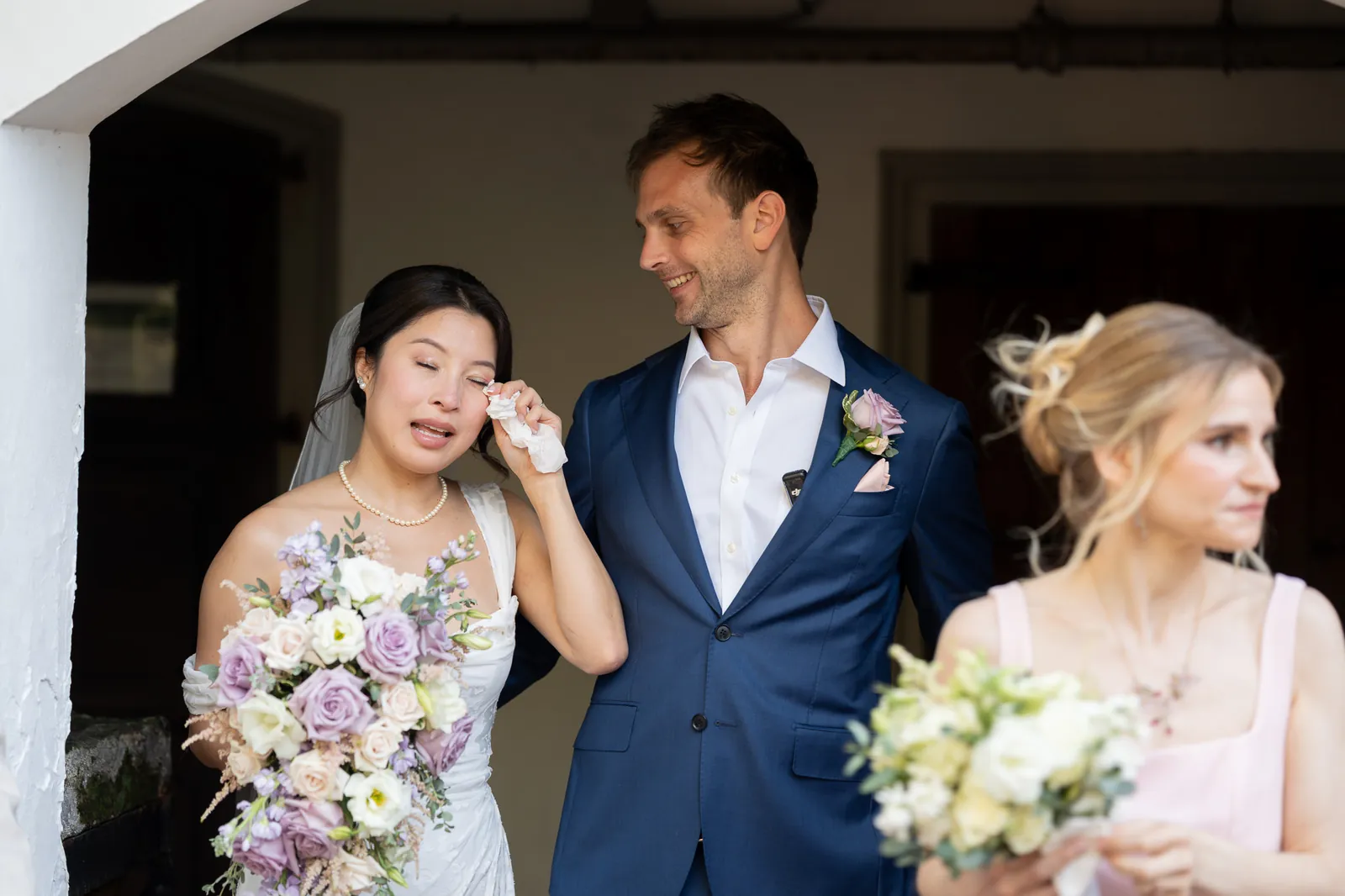 Bride Binh emotional with happy tears as groom comforts her at the Oldest House
